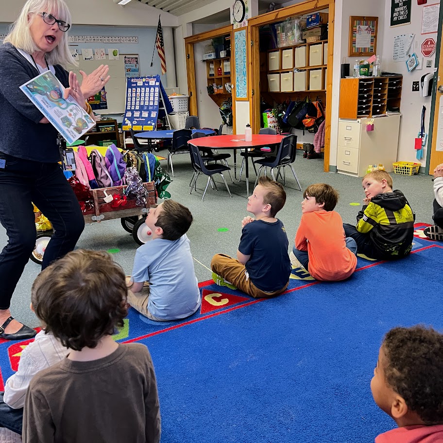 Mrs. Pope presents the adventure book bags to kindergarten. 